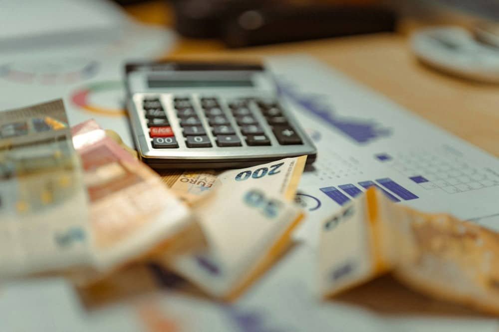 Person working on a budget with calculator and documents